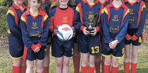 Shebbear U11s girls on ball at soccer tournament