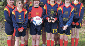 Shebbear U11s girls on ball at soccer tournament