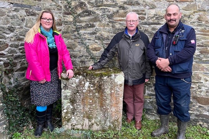 Rhiannon Spurgeon from Tavistock Hub, local historian Simon Dell and Martyn Langsford from South West Water with the boundary stone. 