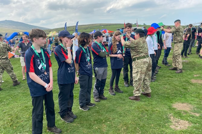 One of the Mount Kelly teams are presented with their finishers' medals