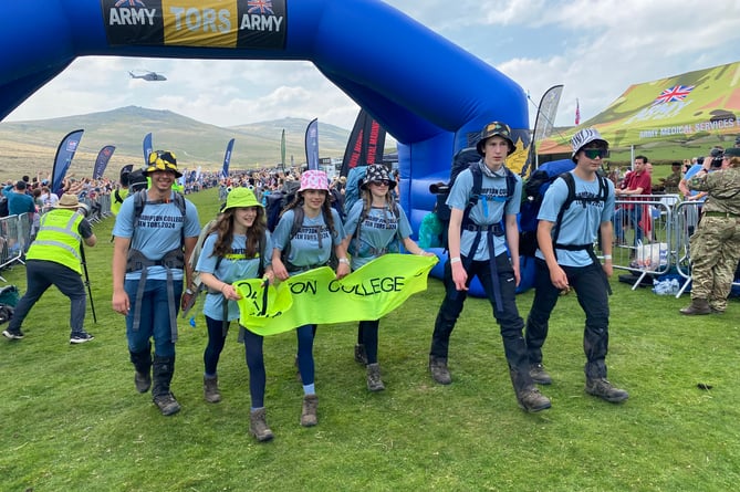 An Okehampton College team cross the finish line