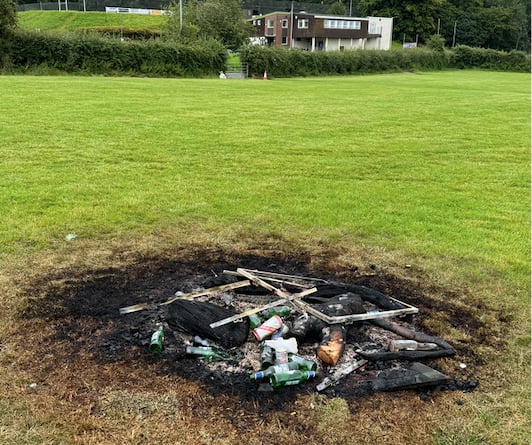 Bottles and other items in the bonfire on the rugby pitch.  AQ 8037