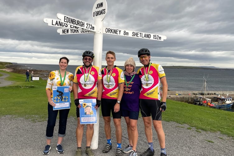 The team at the finish of the ride at John O'Groats, Keri and Paul Thompson are on the left.